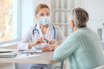 Poster - Doctor measuring oxygen saturation level of patient blood in clinic