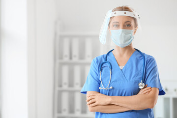 Poster - Portrait of female doctor with protective uniform in clinic