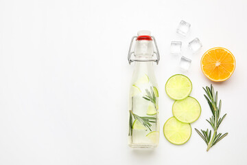  Composition with bottle of healthy lemonade and citrus fruits on white background