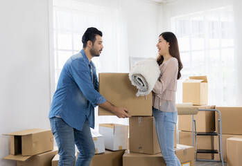 Husband and wife starting a new life just bought a house and moved in. Together they lifted many parcels, moved into the house and arranged.