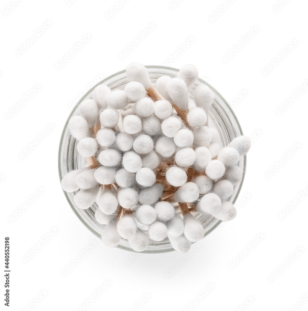 Glass with cotton swabs on white background