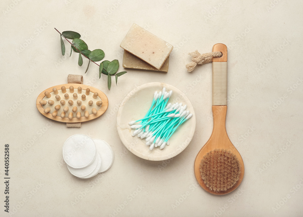 Composition with cotton swabs, comb, brush, soap and buds on light background