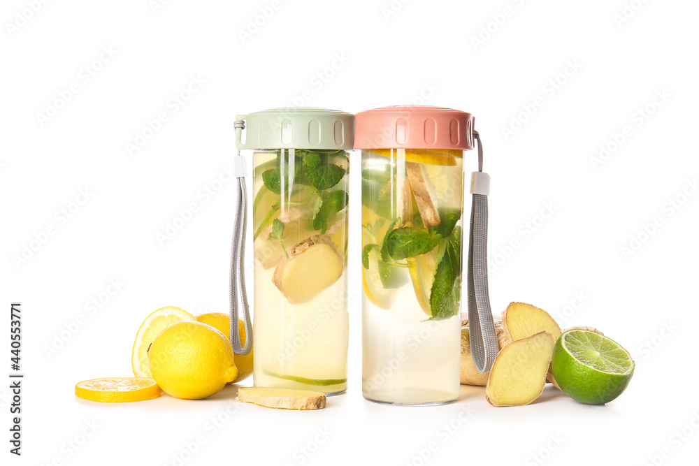 Bottles of cold ginger lemonade on white background