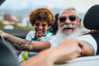 © Alessandro Biascioli - Happy senior couple having fun driving on new convertible car - Mature people enjoying time together during road trip tour vacation - Elderly lifestyle and travel culture concept