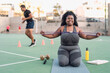 © Alessandro Biascioli - Curvy African woman doing workout exercises session - Young African female having fun training outdoor - Sporty people lifestyle concept