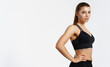 © Liubov Levytska - Confident healthy and athletic woman staring determined at camera, holding hands on hips. Sportswoman exercising in sport clothing, training and workout on white background, isolated
