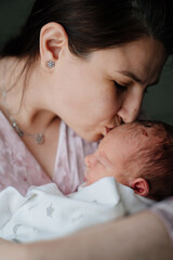 mother with newborn baby in her arms. close-up. happiness of motherhood and love