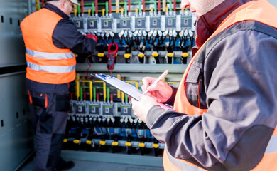 Wall Mural - checking the operating voltage levels of the solar panel switchgear compartment