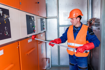 Wall Mural - the engineer checks the absence of induced voltage on the high voltage cells