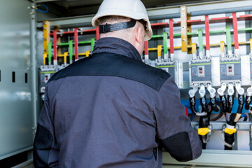Wall Mural - checking the operating voltage levels of the solar panel switchgear compartment