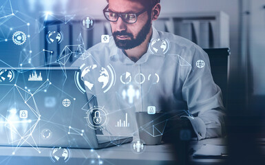 Poster - Beard businessman in glasses with laptop, desktop at office interior, blue glowing information protection icons. Padlock and business data symbols. Concept of cyber security and data storage