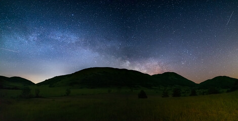 Wall Mural - panoramic night sky over montelago highlands, marche, italy. the milky way galaxy arc and stars risi