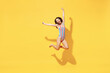 © ViDi Studio - Full length fun happy young sexy woman slim body wear striped red blue one-piece swimsuit jump high air run fly isolated on vivid yellow color background studio Summer hotel pool sea rest sun concept