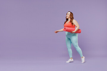 Wall Mural - Full length side view surprised young chubby overweight plus size big fat woman wear red top warm up train hold yoga mat walk isolated on purple background gym home. Workout motivation sport concept