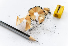 A Sharpened Pencil With Shavings Isolated With A White Background.