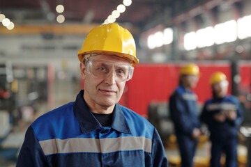 Poster - Portrait of content mature manufacturing worker