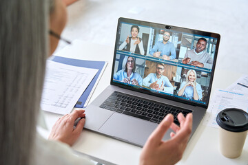 Wall Mural - asian mid age businesswoman ceo executive manager in headset having working videocall on financial r