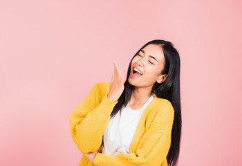 Wall Mural - Happy Asian portrait beautiful cute young woman standing winning and surprised excited screaming laugh hand cover mouth, studio shot isolated pink background, Thai female wow scream with copy space