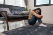 © PK Studio - Young woman lying at home living room couch feeling sad tired and worried suffering depression in mental health