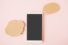 White Smart Phone With Clipping Path On Touchscreen , Couple Of Blank Grunge Brown Bubble Speech Paper On Sweet Pink Background , Communication , Network, Social Distancing Concept