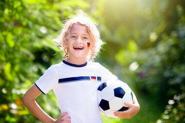 Germany football fan kids. Children play soccer.