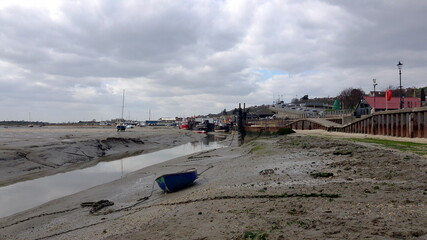 Fisherman boats stuck on the beach in low tide period.