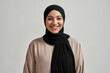 Portrait of smiling young arabic woman in black hijab