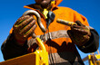 Safety workplace close up image of trained competent rigger high risk worker wearing safety heavy duty glove inspecting D- shape shackle pin prior inserting into crane lifting lug cate during lifting