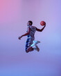 © Nomad_Soul - Basketball player jumping with ball in studio