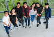 © Bangkok Click Studio - Bird-eye view portrait shot of a group of seven young male and female teenagers standing and looking to the camera. College friends taking a photo together with cute smiling. Concept of relationship