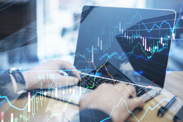 Poster - Close up of hands using laptop with forex chart on blurry desktop background. Finance and fintech concept. Double exposure.