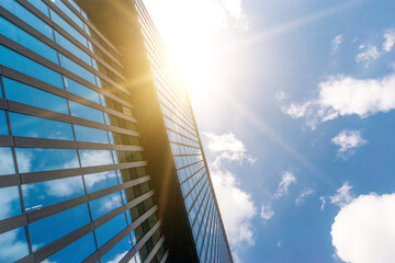 Business building architecture. Finance corporate architecture city in abstract blue sky with nature cloud in sunny day. Modern office business building with glass, steel facade exterior.