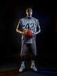 © Nomad_Soul - Focused basketball player holds ball in studio