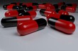 Selective focus of antibiotic red black capsule pills on black background. with copy space. Drug resistance concept. Antibiotics drug use with reasonable.Mock up. 3D render