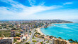 Alicante town from Serra Grossa mountain. Cabo de la Huerta and San Juan district with high buildings, roads, beaches and rugged shoreline of Mediterranean sea. Costa Blanca region in Spain from above