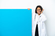 © luismolinero - Young mixed race doctor woman with a big placard isolated on white background frustrated and covering ears