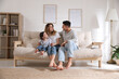 © New Africa - Happy family with little daughter sitting on sofa in living room
