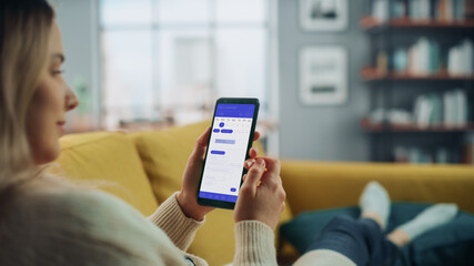 Aufkleber - Beautiful Authentic Female Using a Smartphone with Calendar Application at Home Living Room while Lying on a Couch Sofa. She's Making Plans and Checking Event Schedule for a Day.