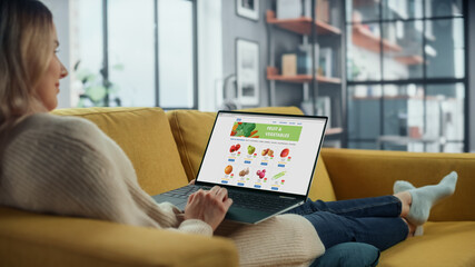 Aufkleber - Beautiful Caucasian Female is Using Laptop Computer for Ordering Delivery of a Fresh Fruits and Vegetables. She is in Home Living Room. Freelance Specialist Working From Home, Surfing the Internet.