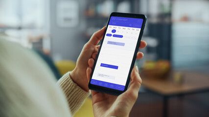 Poster - Beautiful Authentic Female Using a Smartphone with Calendar Application at Home Living Room while Lying on a Couch Sofa. She's Making Plans and Checking Event Schedule for a Day.