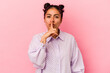 © Asier - Young latin woman isolated on pink background keeping a secret or asking for silence.