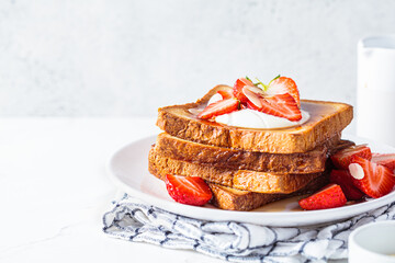 Canvas Print - A stack of French toast with strawberries, yogurt and maple syrup. Breakfast concept.