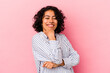 © Asier - Young curly latin woman isolated on pink background smiling happy and confident, touching chin with hand.