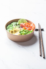 Wall Mural - Poke bowl with rice, salmon, edamame beans, cucumber and avocado in reusable cardboard bowl. Hawaiian food. Zero Waste concept.