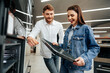 © fotofabrika - Young couple choosing new electric oven in hypermarket