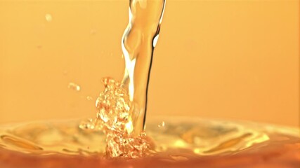 Poster - Super slow motion apple juice pours with splashes. On a yellow background. Filmed on a high-speed camera at 1000 fps.