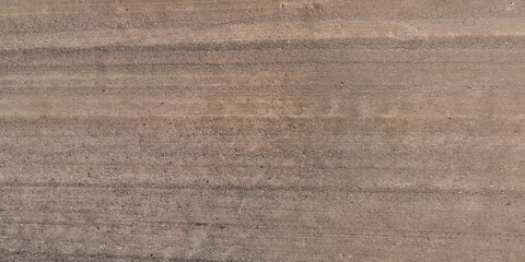 Wall Mural - view from above on car tire tracks on surface of gravel road