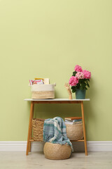 Poster - Console table with beautiful hortensia flower near light green wall in hallway. Interior design