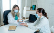 © SB Arts Media - Female doctor prescribing medication to patient