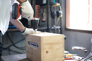 DIY work at home, Man screwing speaker cabinet, Close up.